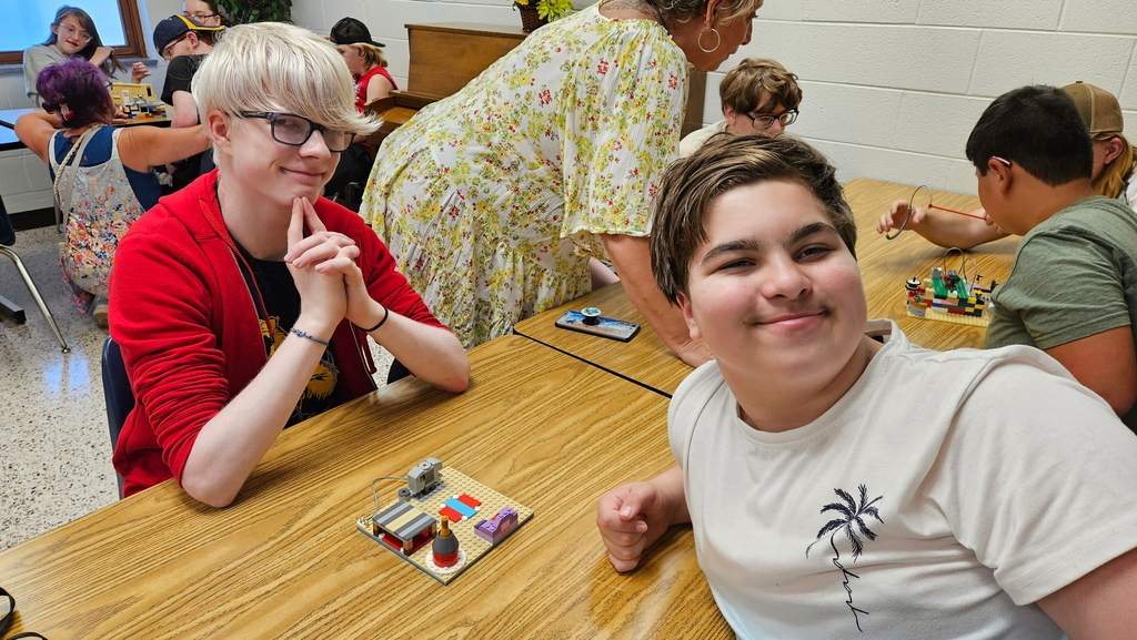 Two male students smile while looking at the camera.
