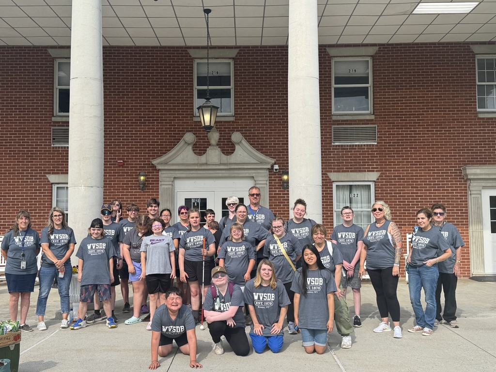 A group photo of camp participants in front of the Keller Hall Residential Hall.