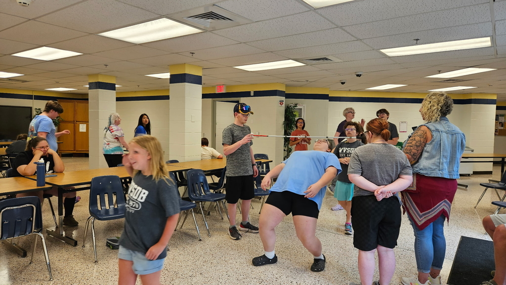 Camp participants participate in a game of "limbo."
