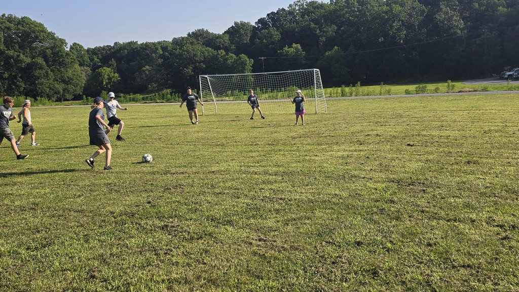 Camp participants running on the soccer field. 