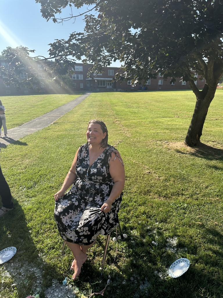Mrs. Hesse smiles at the camera as she is seated in a chair.