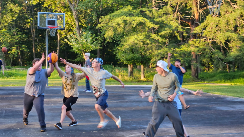 Students racing to get the orange and purple basketball.