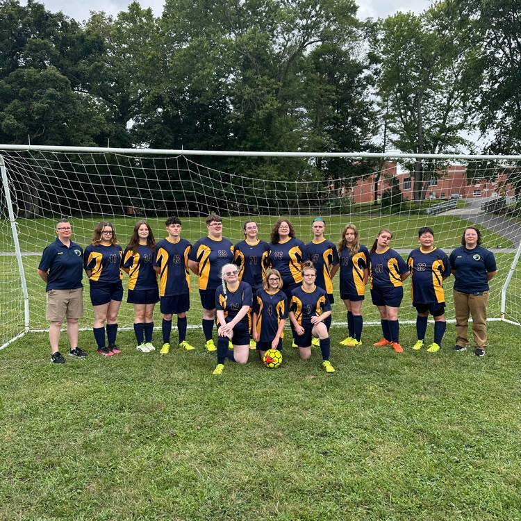 2025 WVSDB co-ed Soccer team group photo with team members and coaches standing in front of a soccer net.