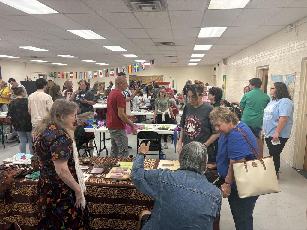 Students mingling with vendors who are set up at the celebration.