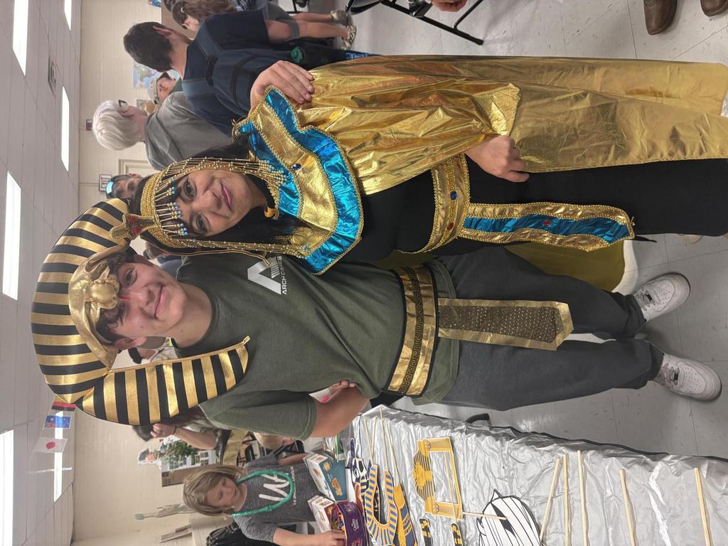 A male student and Mrs. Youssef pose for a photo while wearing Egyptian attire.