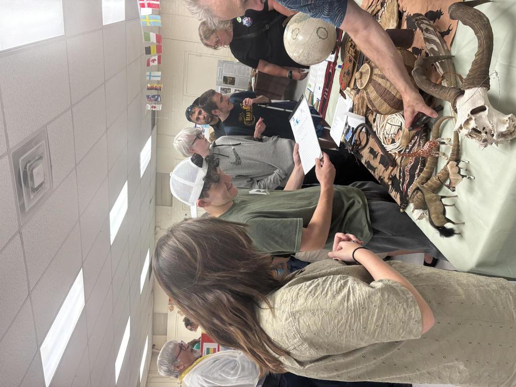 Students mingling at a vendor table that is set up.