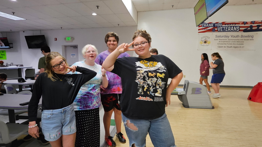 Students flash the "peace" sign while at the bowling alley.