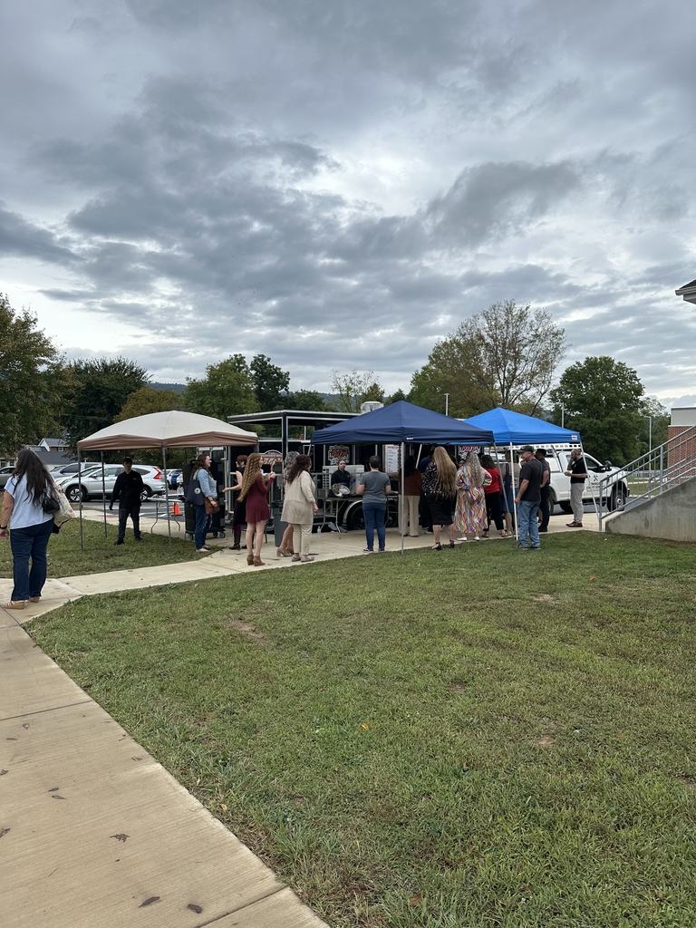 Conference attendees lining up to order food from Country Roads Blazin' BBQ food truck.