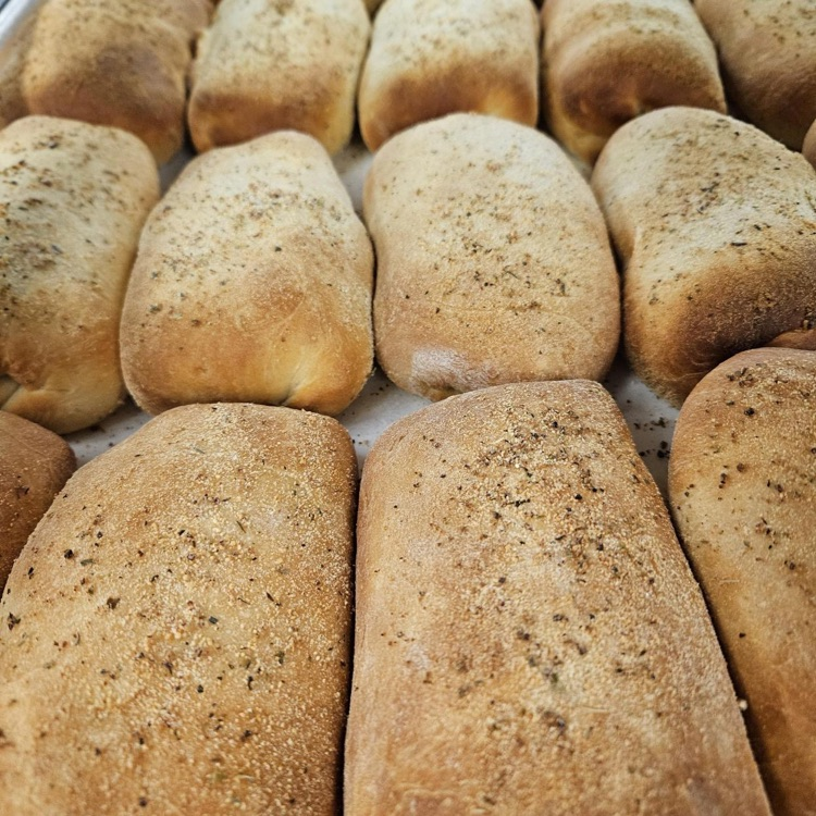 Up-close photo of pepperoni rolls on a baking tray.
