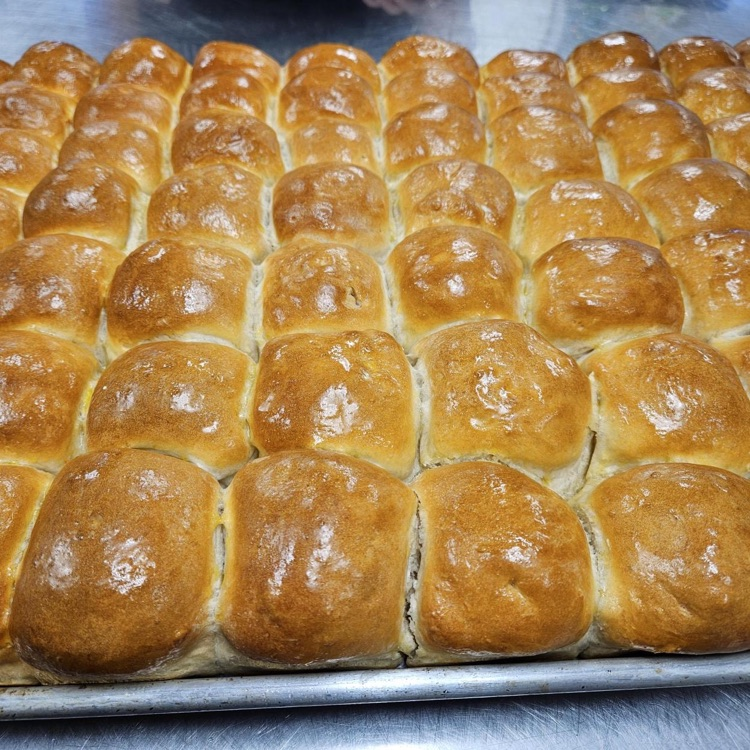 Fresh made rolls on a baking tray.