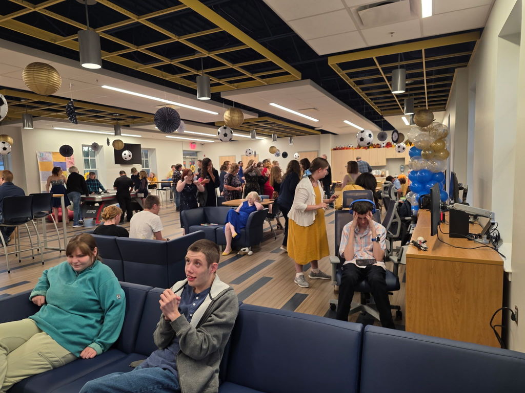 Students mingling and dancing with one another.