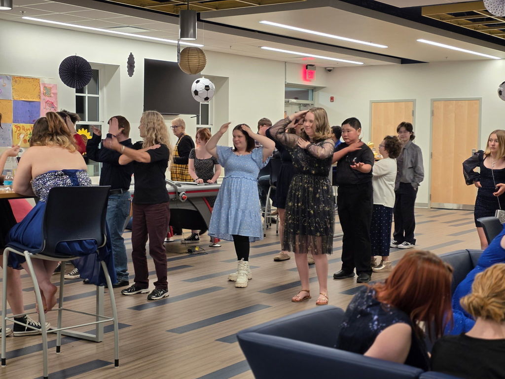 A group of students dancing with one another.