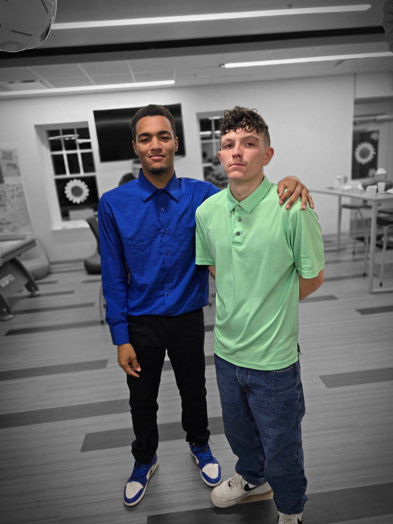 Two male students stand side-by-side for a photo.