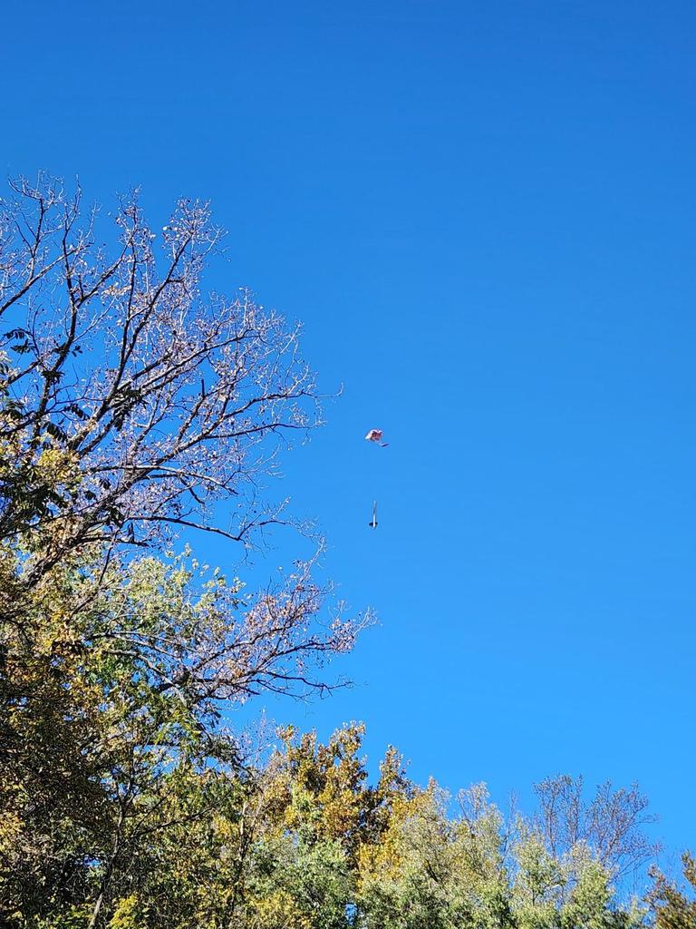 The rocket after it was launched coming down to the ground with its parachute.