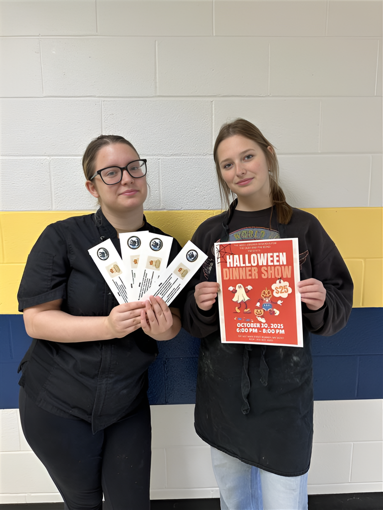 Two female students, Bindi and Bray stand side-by-side holding up tickets and a Halloween Dinner Show flyer.