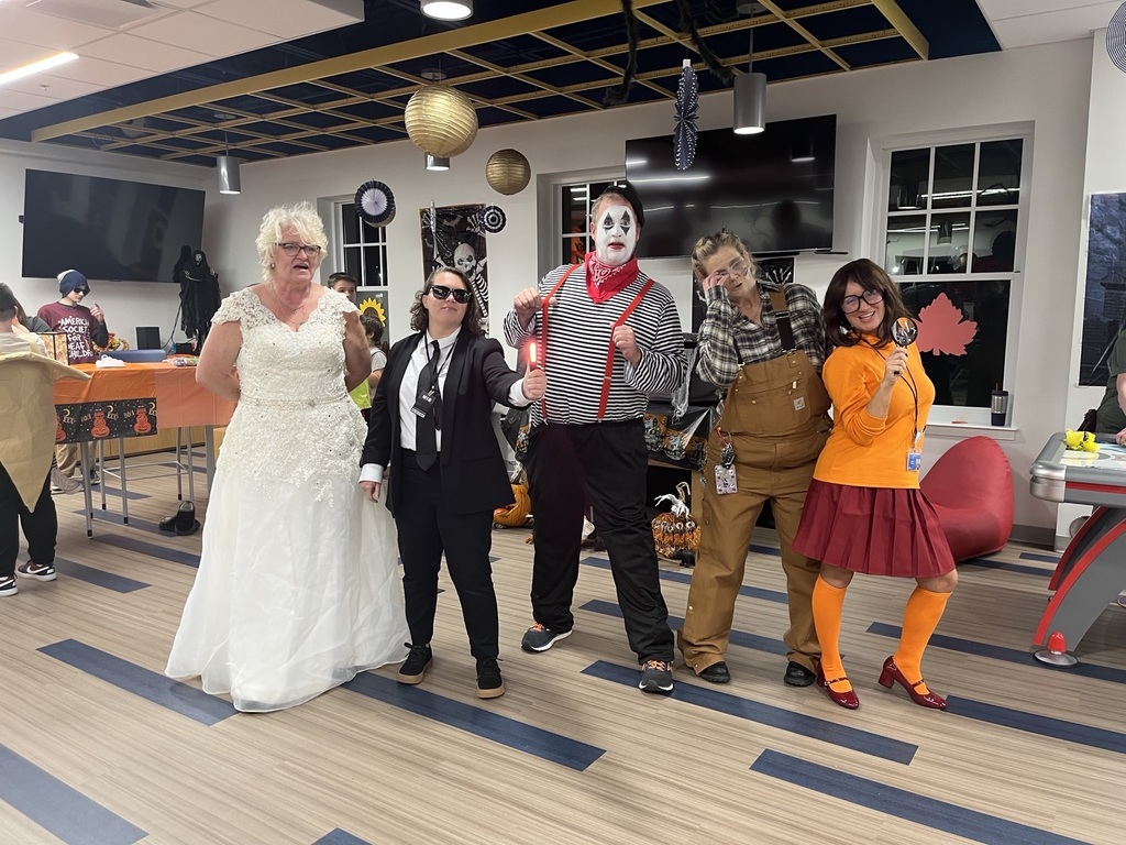 Residential Care Specialists (RCS) stand together and pose in their Halloween costumes.