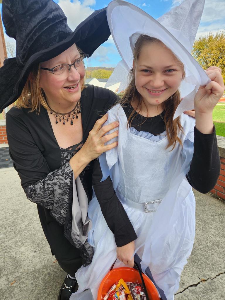 Dr. Ashworth dressed as a witch poses with a female student who is also dressed as a witch.