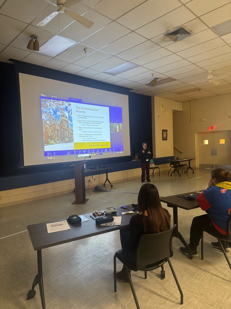 Participants observe a presentation using a large screen on "the accommodation process."