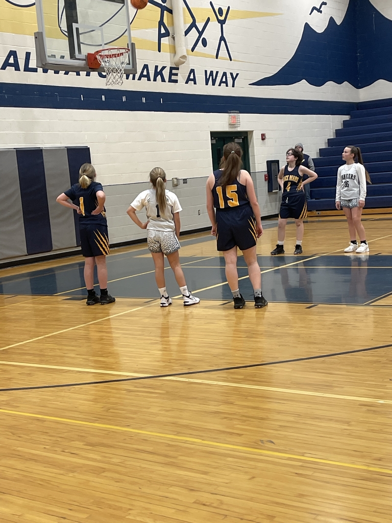 Girls basketball players lined up for a foul shot.