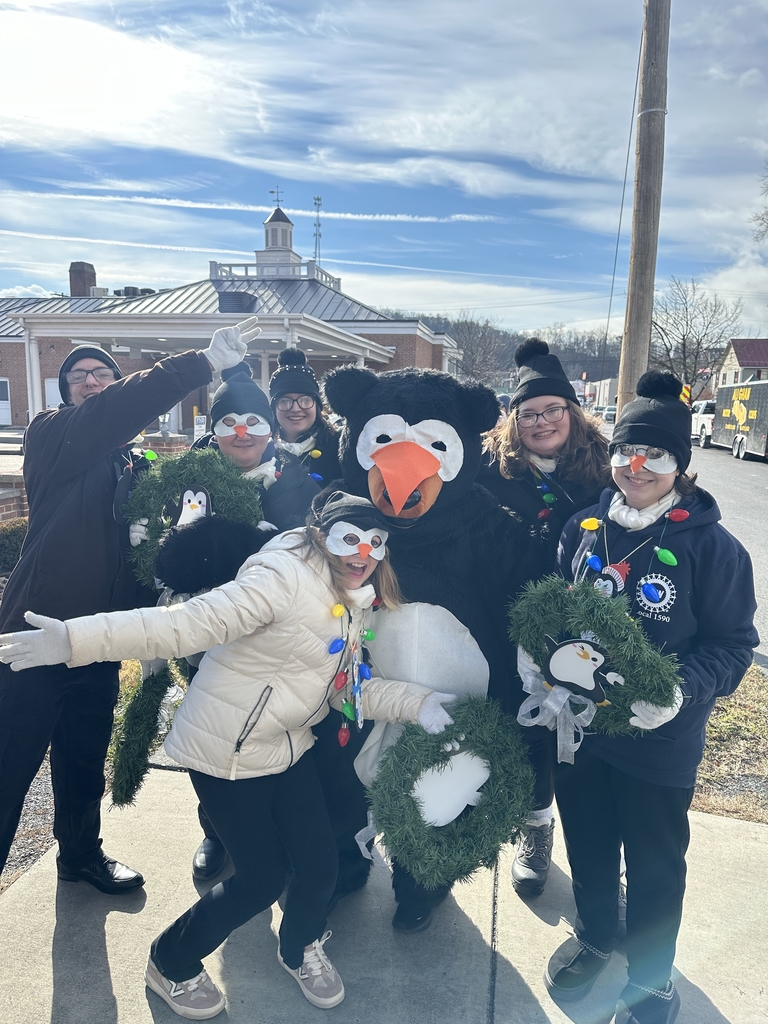 A group of students pose for a silly photo with the WVSDB Black Bear mascot.