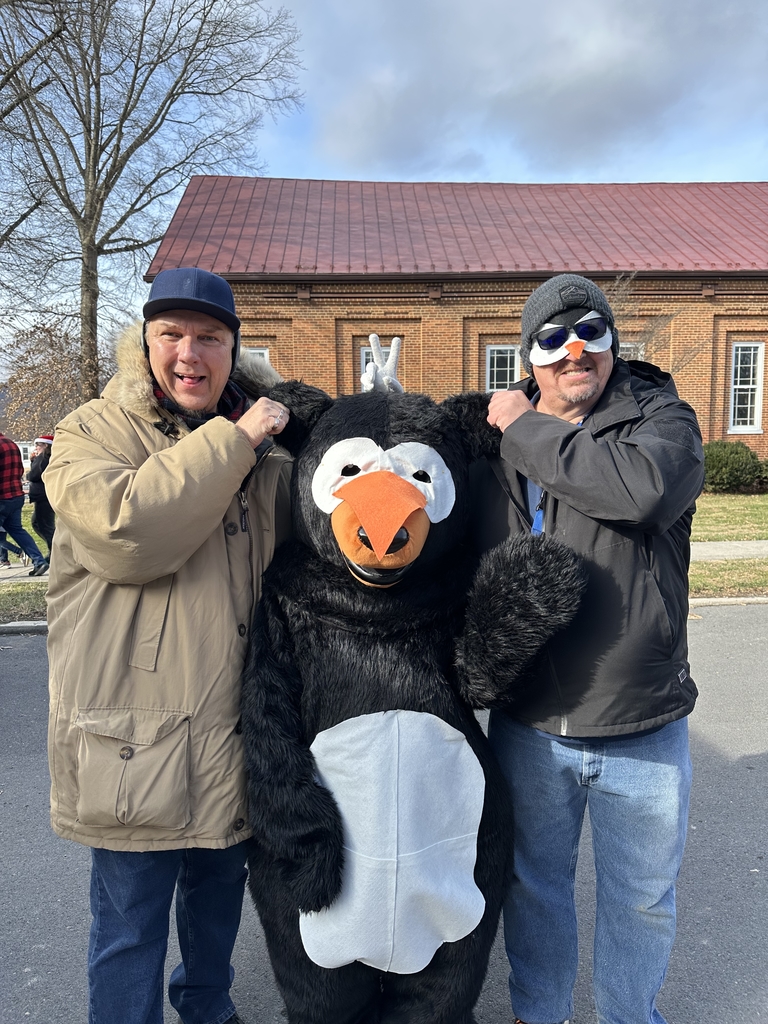 Two male staff members pose for a silly photo with the WVSDB Black Bear mascot.