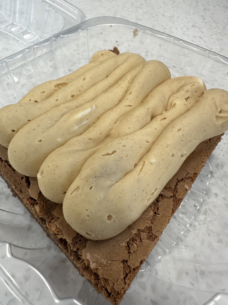 Large chocolate brownie with peanut butter frosting on the top. 