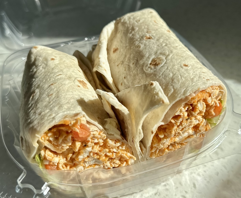 Buffalo chicken wrap. Chicken tossed in buffalo sauce with cheese, tomatoes, and lettuce wrapped in a tortilla. 