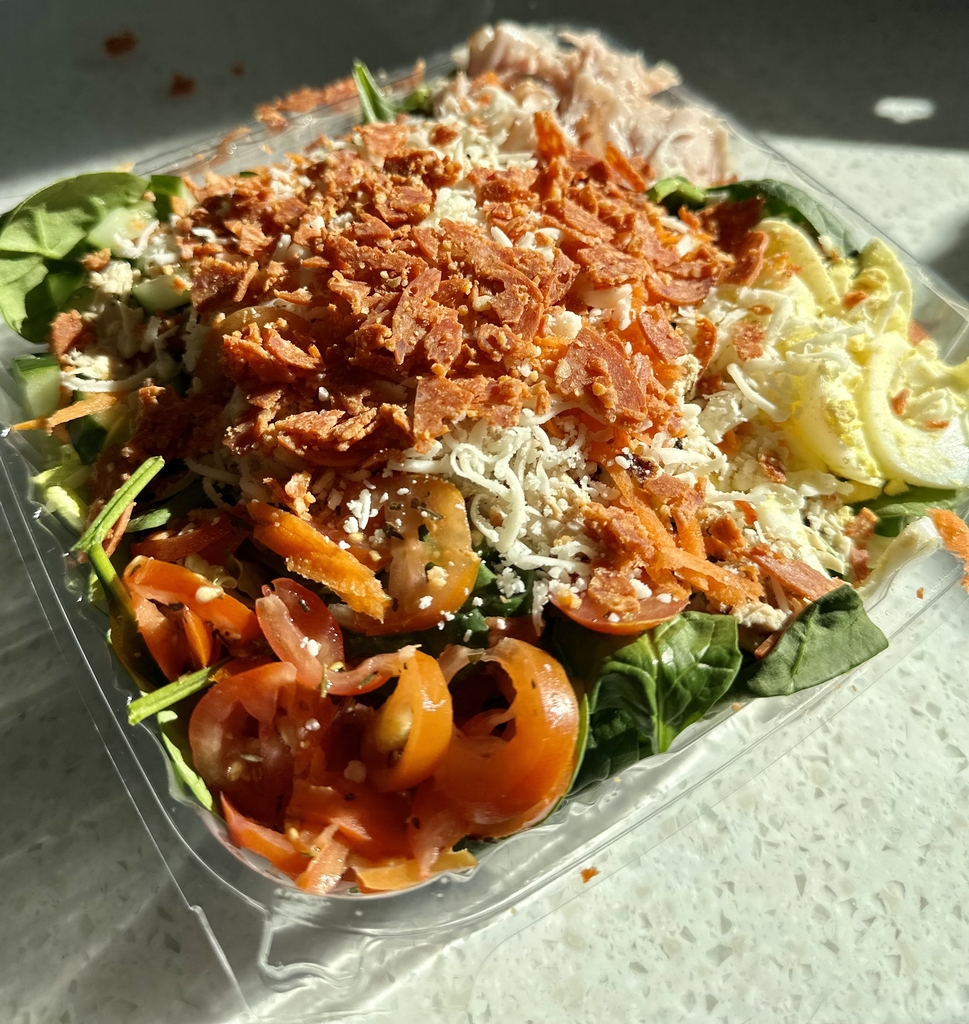 Chef salad. Pepperoni, salami, tomatoes, boiled eggs, tomatoes on a bed of green lettuce. 