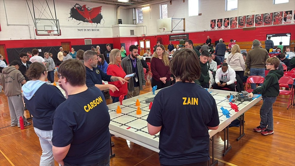 WVSDB Bearbots team members gathered around a robotics arena.