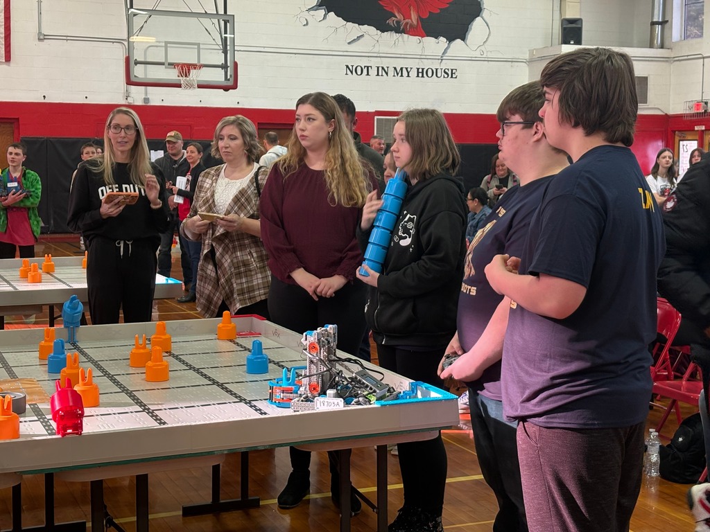 WVSDB Bearbots team members gathered around a robotics arena.