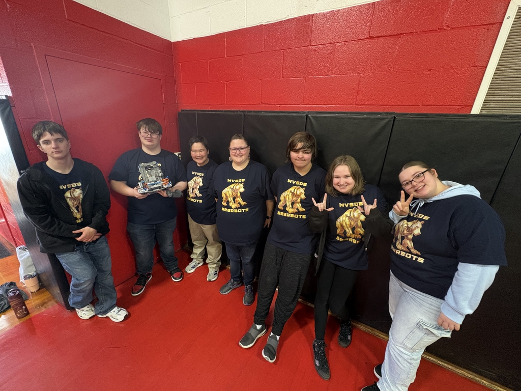 Group photo of the WVSDB Bearbots Robotics team standing side-by-side wearing matching t-shirts. Coach Dosch is standing in the middle of the team. 