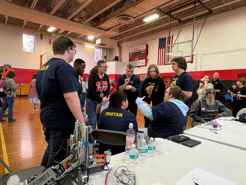 The WVSDB Bearbots team gathered in a circle while being interviewed by a female judge.