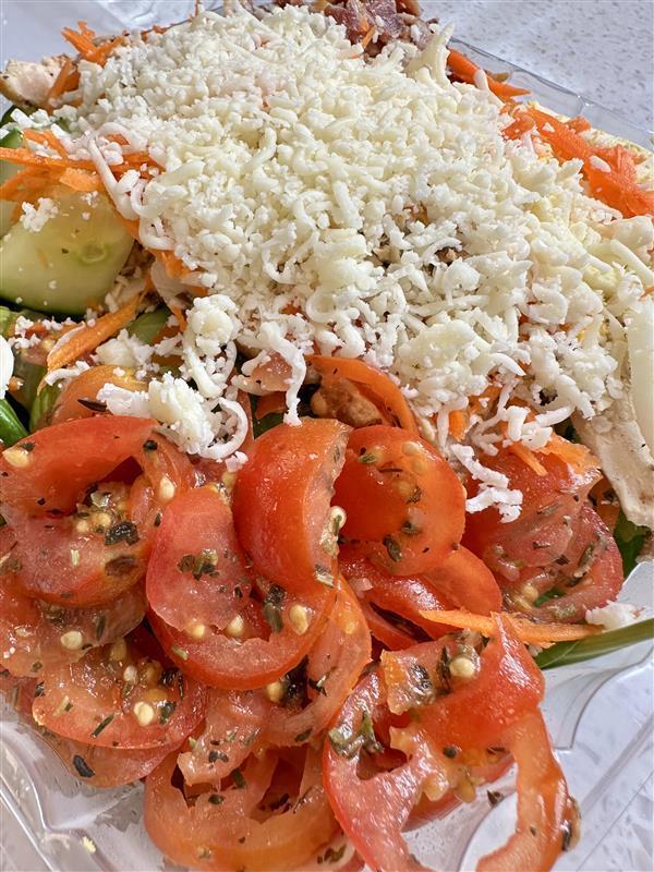 Chicken BLT Salad. Chicken, cheese, cucumbers, and tomatoes all on a bed of lettuce. 