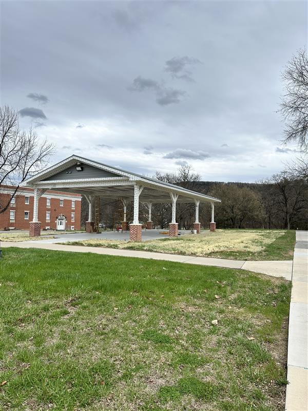 An outdoor pavilion with construction continuing on the roof.
