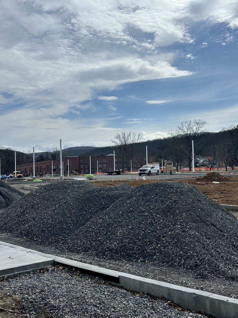 Light poles are placed where the new bus loop will be.