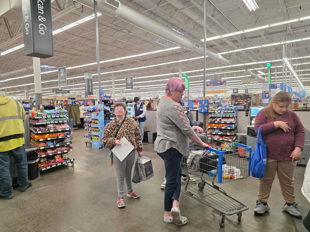 Students waiting in the self-checkout line in Walmart.