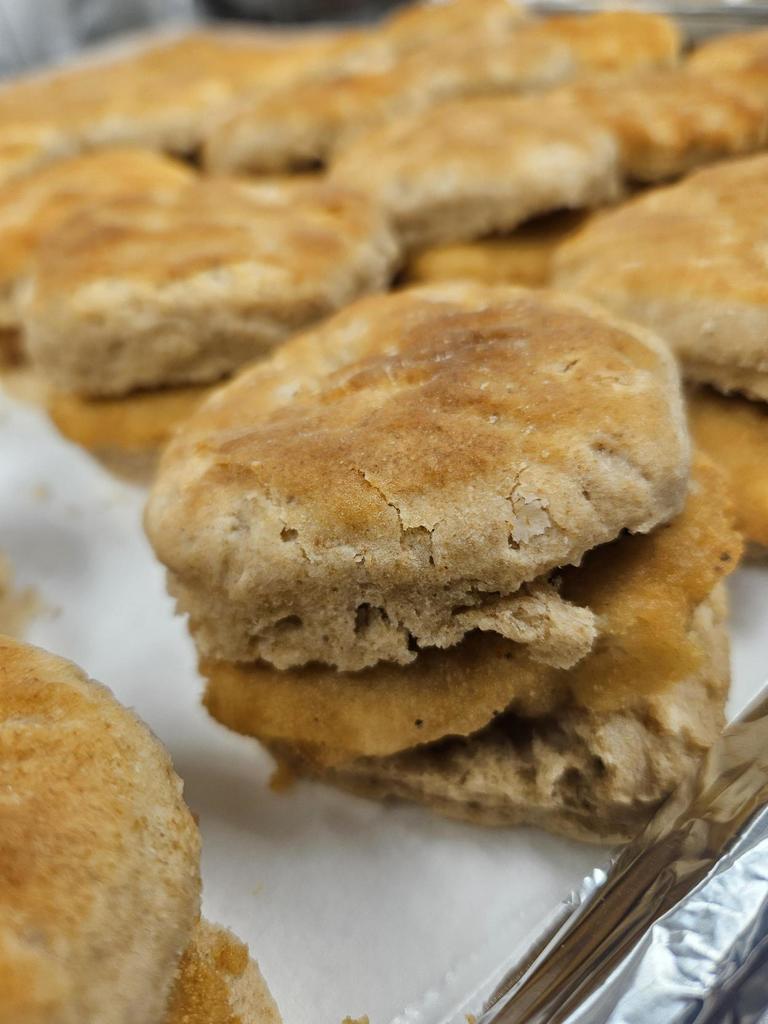 Up-close photo of a chicken filet on a biscuit.