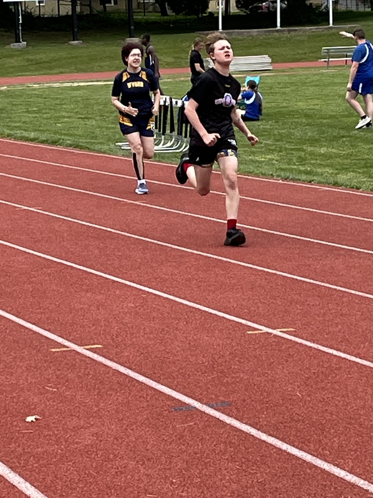 Two athletes are running on a red-colored track.