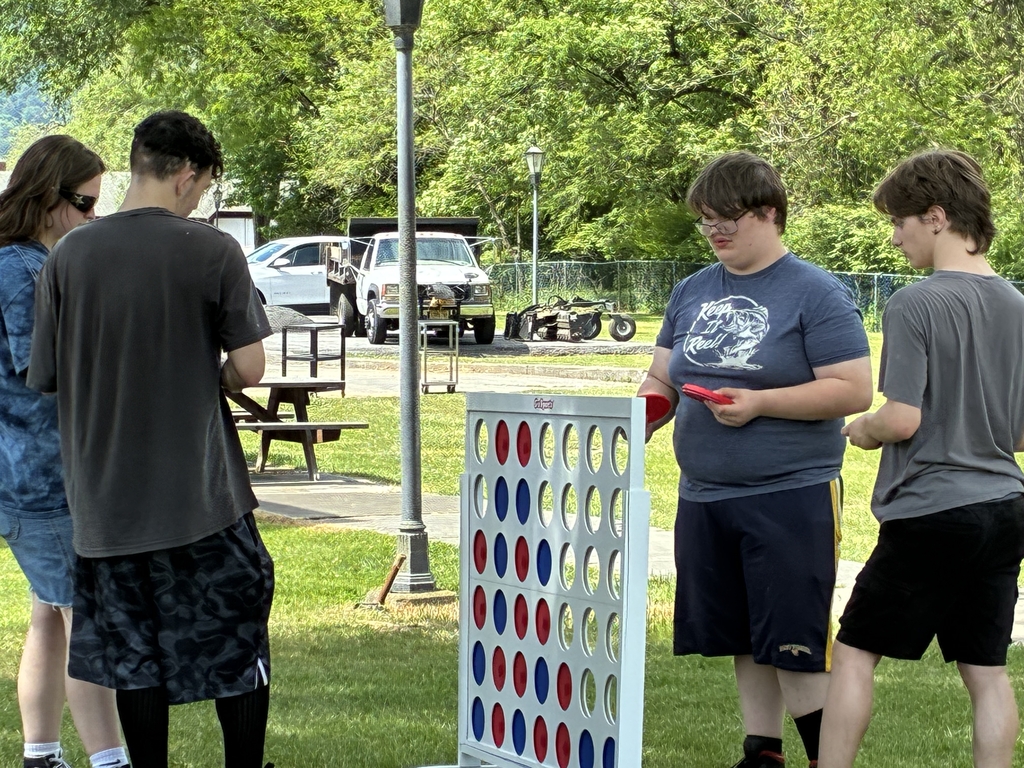 Students gathered around playing a game of giant connect four.