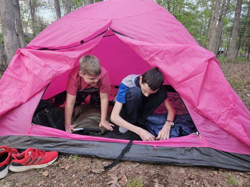 Two Scouts, Aiden and Wyatt put up a pink-colored tent.