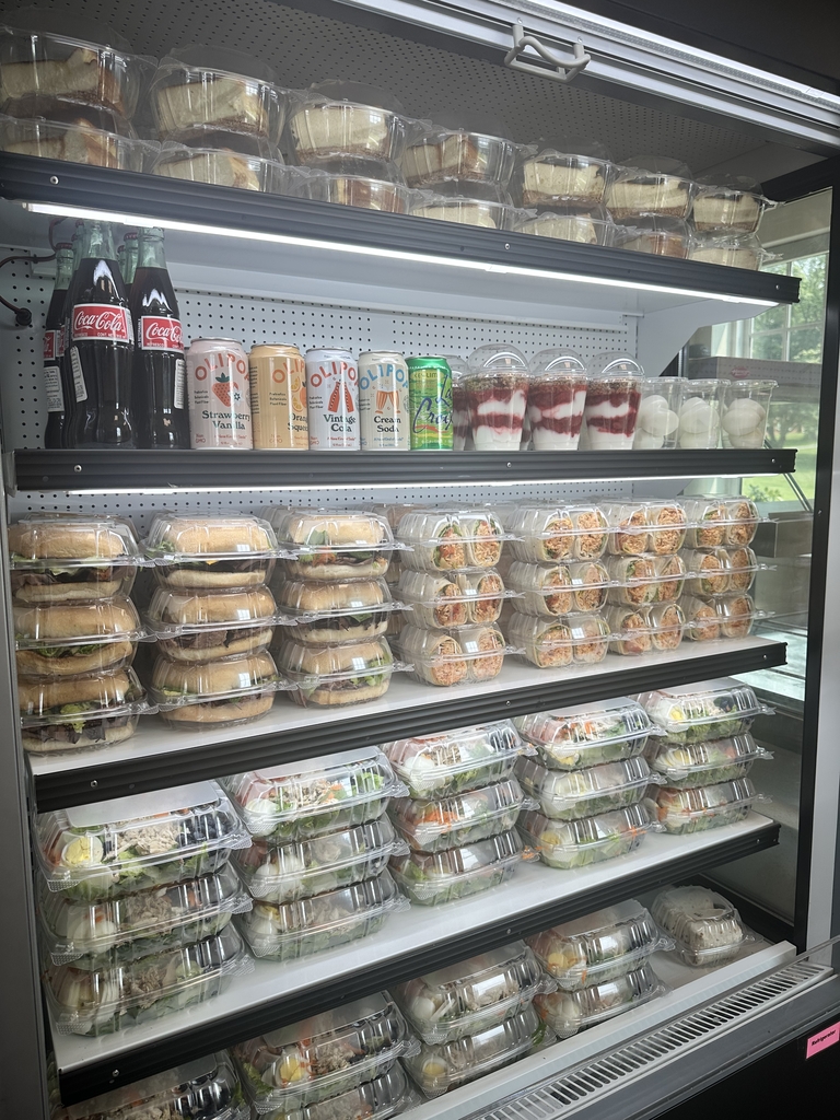 Cooler filled with food and beverage items neatly stacked in rows.