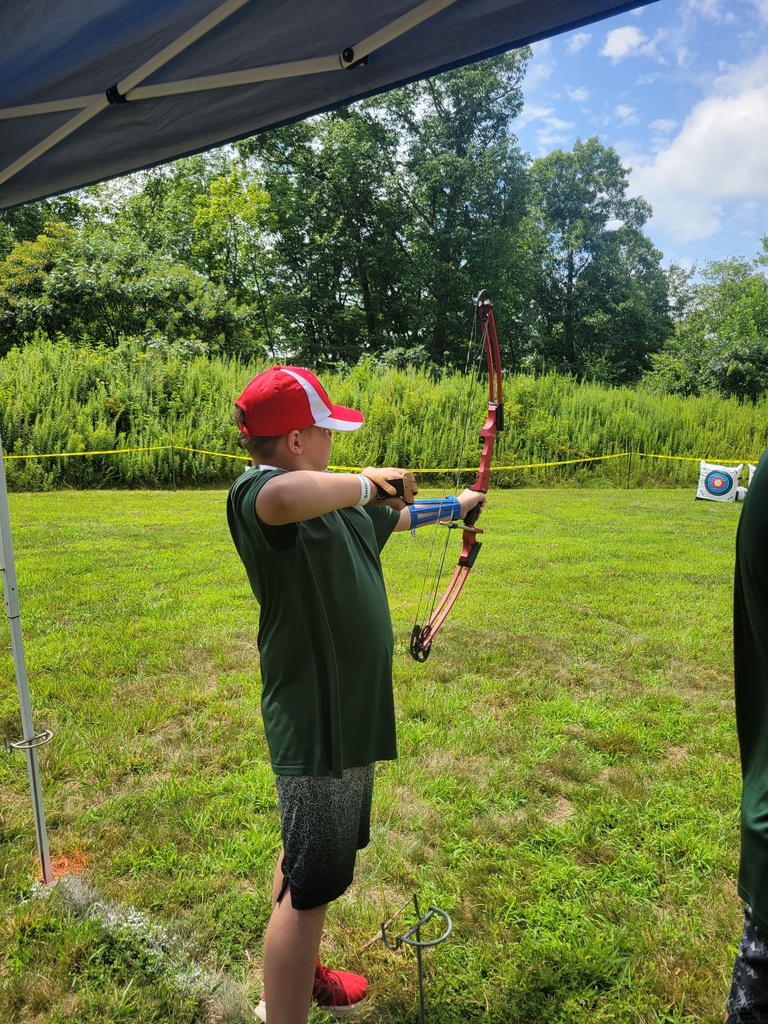 A Scout practices proper archery form while aiming a recurve bow during National Jamboree archery activities.