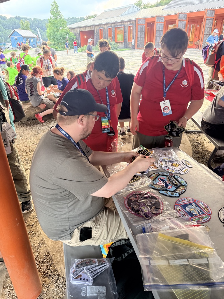 Scouts browse and trade collectible patches with another participant during the National Jamboree.