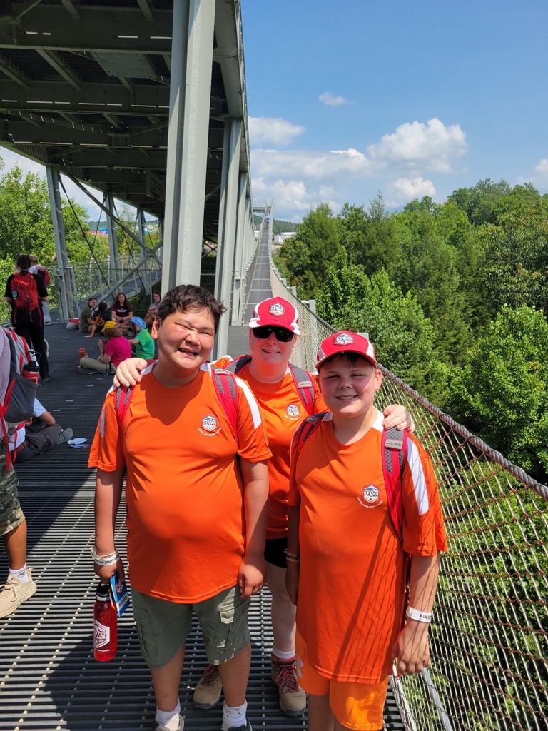 Two WVSDB Boy Scouts and their Troop Leader pause for a photo while crossing a long suspension bridge during an 8.5-mile hike at the National Scout Jamboree.