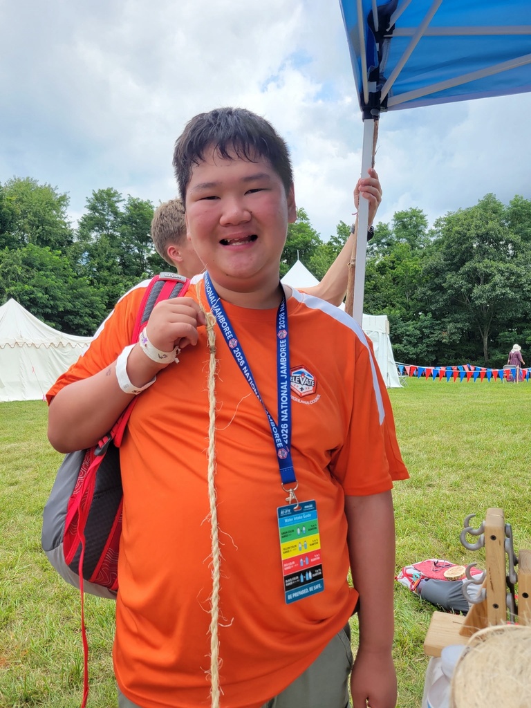 A WVSDB Boy Scout proudly displays a handmade rope during a rope-making activity at the National Scout Jamboree.