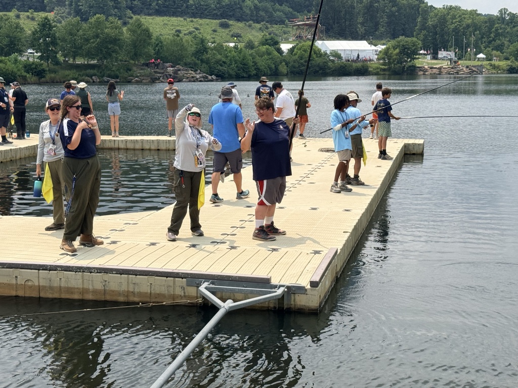 WVSDB Boy Scouts fish from a floating dock during the National Scout Jamboree while other Scouts cast their lines nearby.