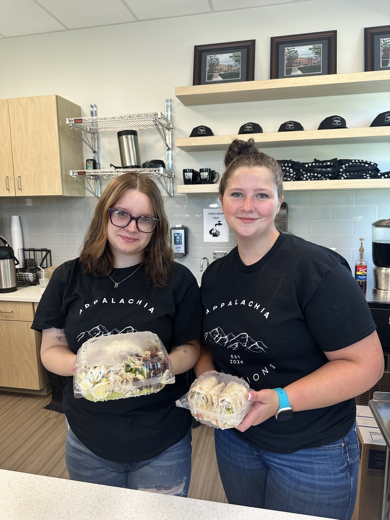 Students in the Appalachia Provisions culinary program display freshly prepared grab-and-go meals at the student-operated café, where branded merchandise and a coffee service are featured behind the counter.