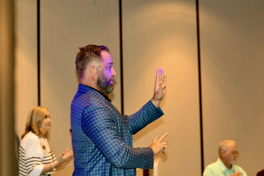 An interpreter uses sign language during a session at the 2026 WVSDB Interpreter Summit.