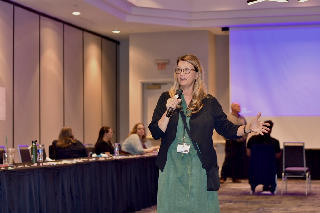 A presenter speaks into a microphone while addressing attendees during the 2026 WVSDB Interpreter Summit.