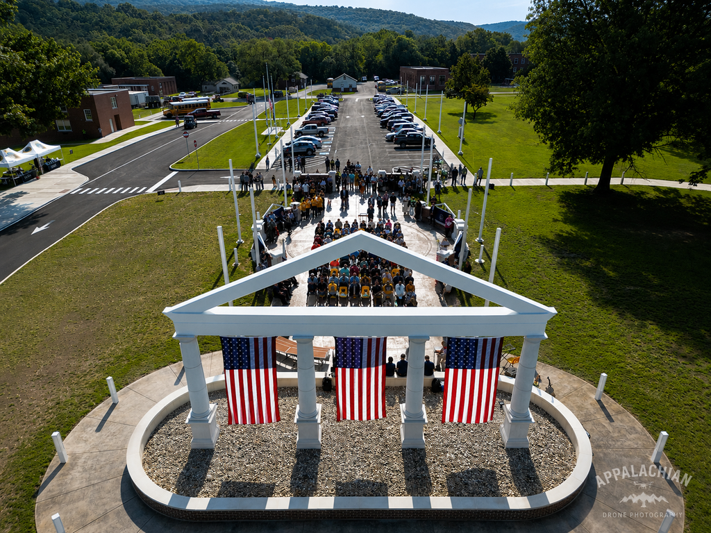 Top-down aerial view of the Administration Building Memorial and guests gathered for the ribbon-cutting and dedication ceremony.
